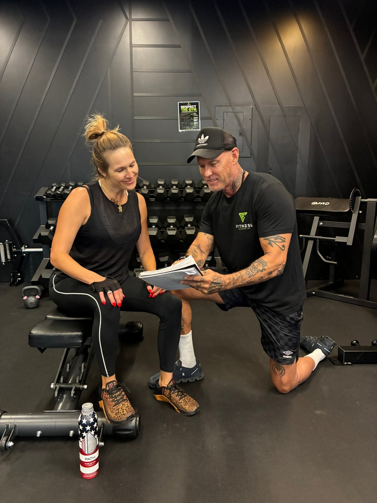 Coach reviewing a personalized program with a client at Fitness Covered